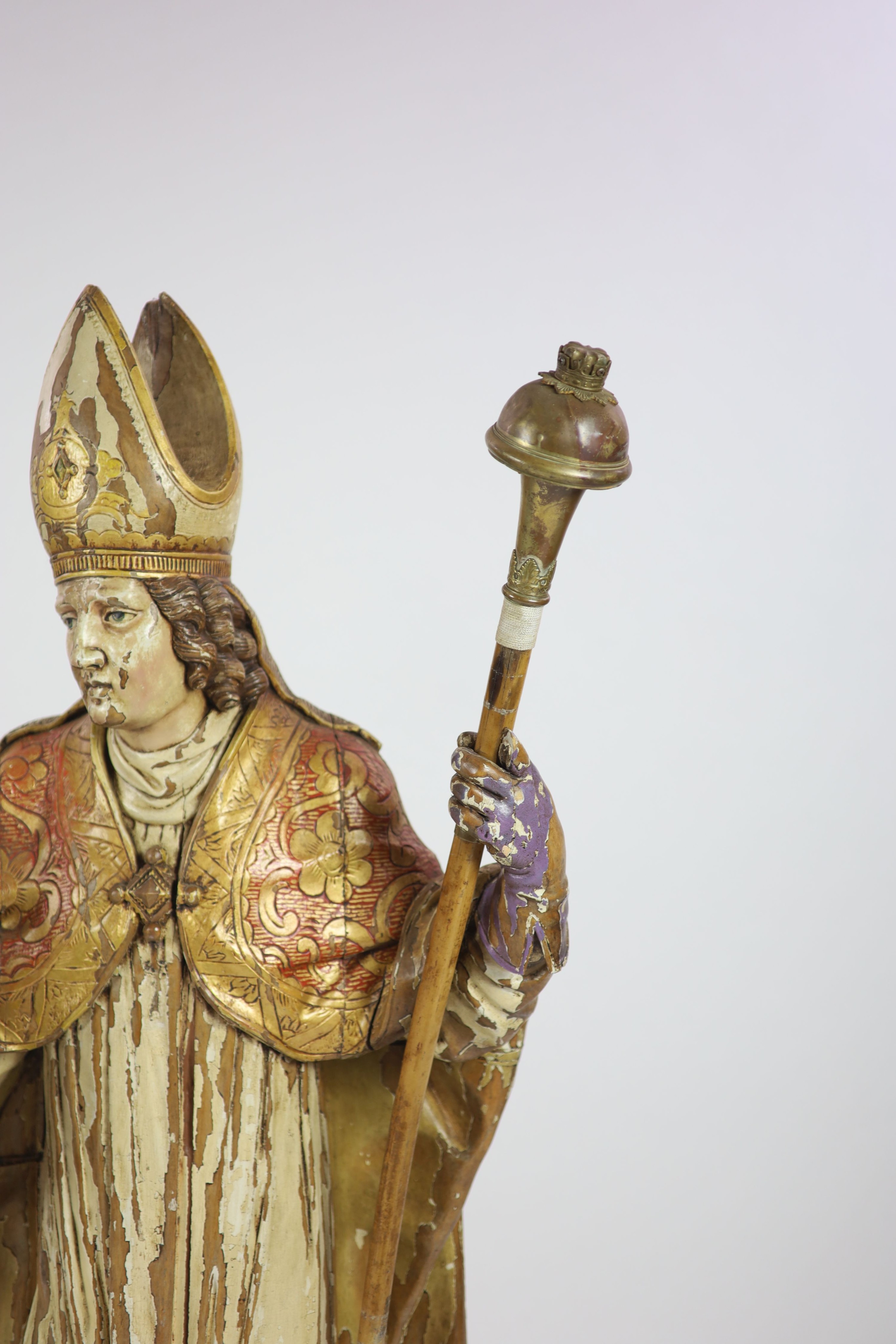 A 19th century German painted carved wood figure of St Ludgerus (b.742) H 157cm.